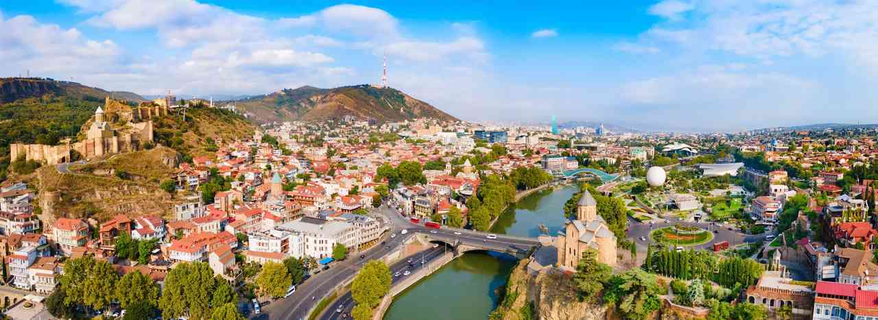 Panoramic view of Tbilisi Old Town with traditional balconies and Narikala Fortress